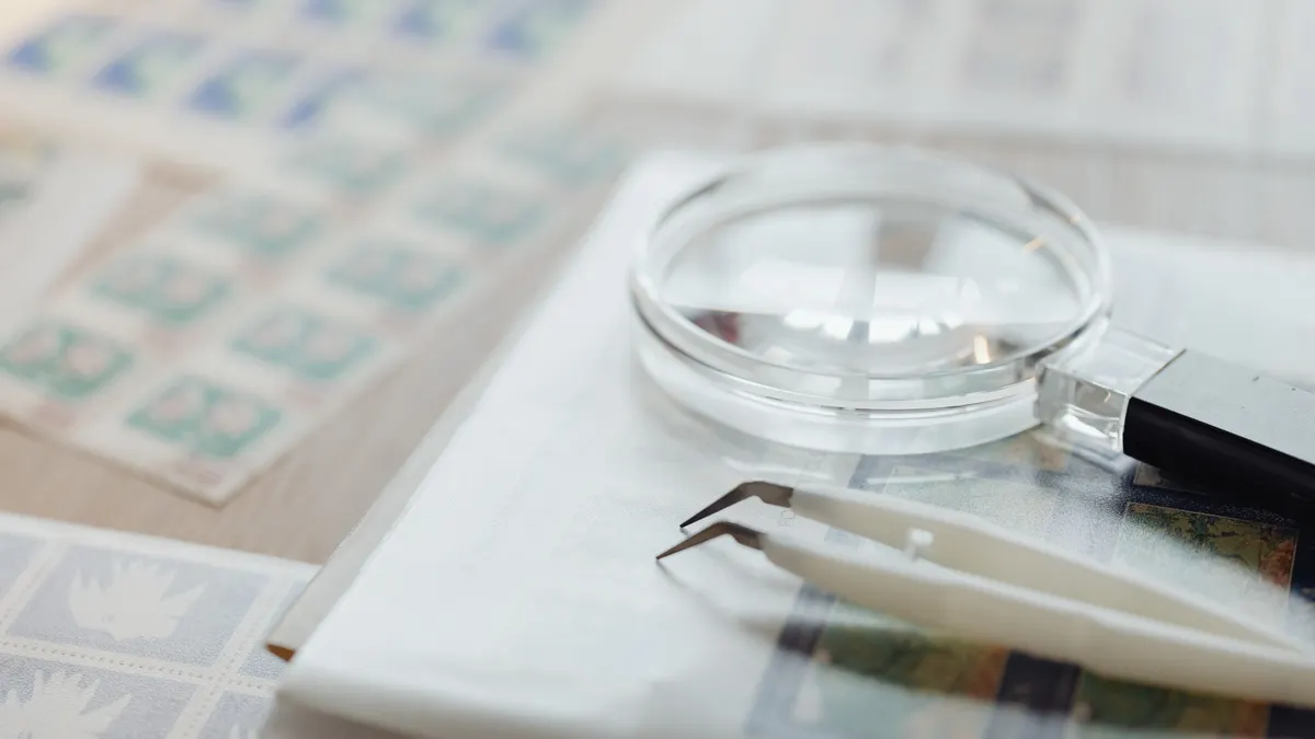 Magnifying glass and tweezers on documents