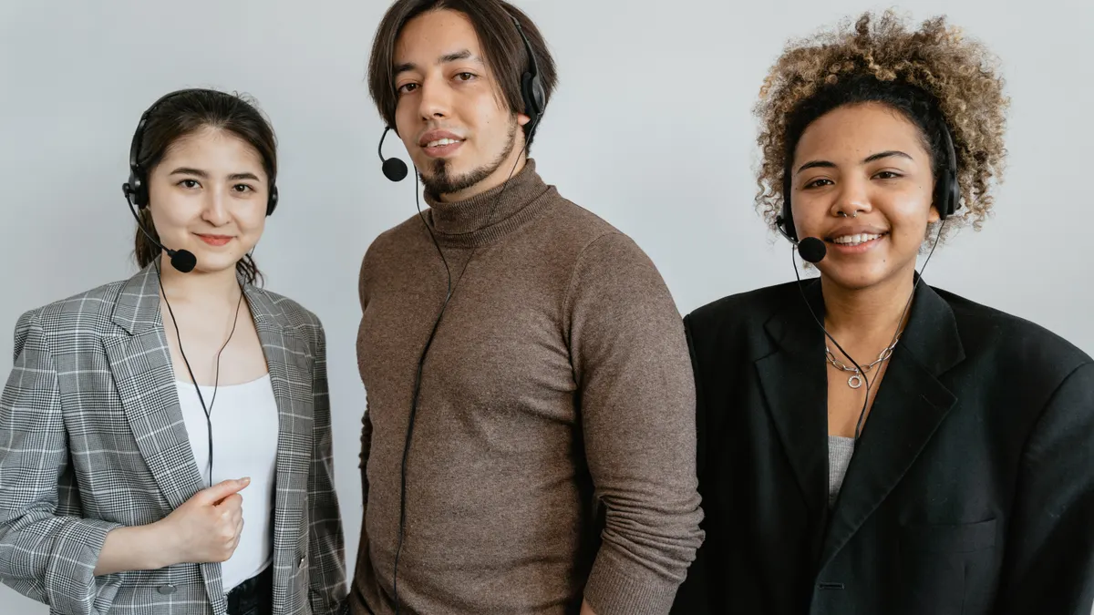 three customer support agents wearing headsets