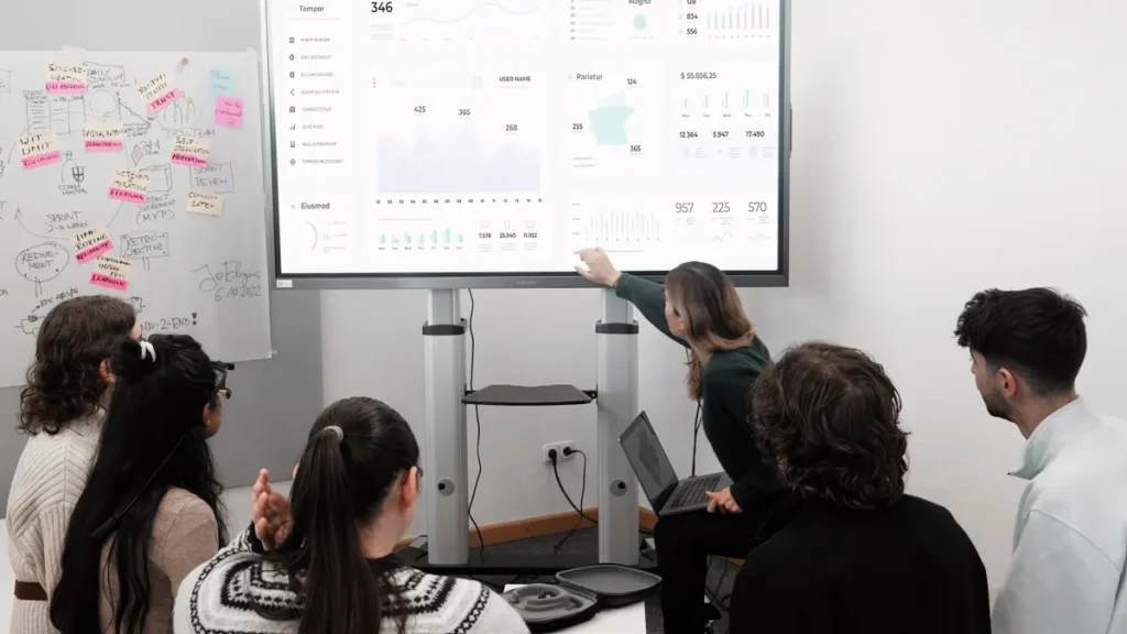 team viewing a large analytics dashboard