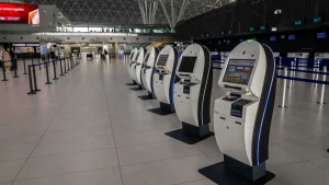 row of self-service airport check-in kiosks