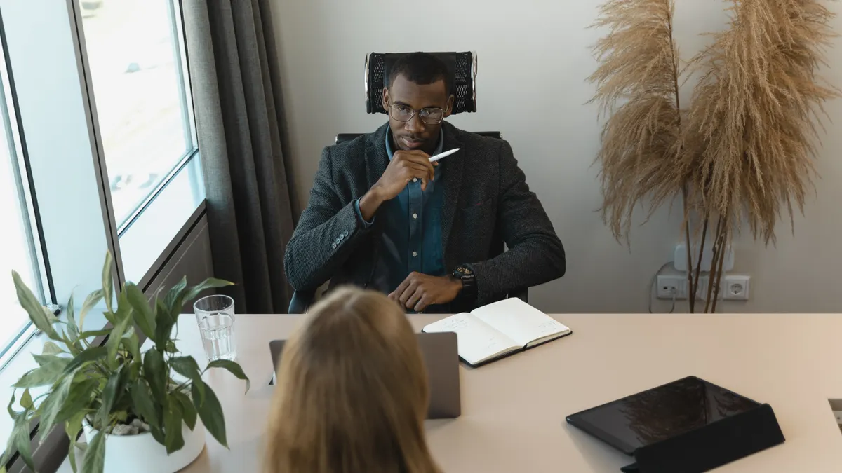 Cluster F hiring guide for early SaaS teams: key roles, compensation signals, and interview templates Cluster F hiring guide for early SaaS teams: key roles, compensation signals, and interview templates — Man Interviewing