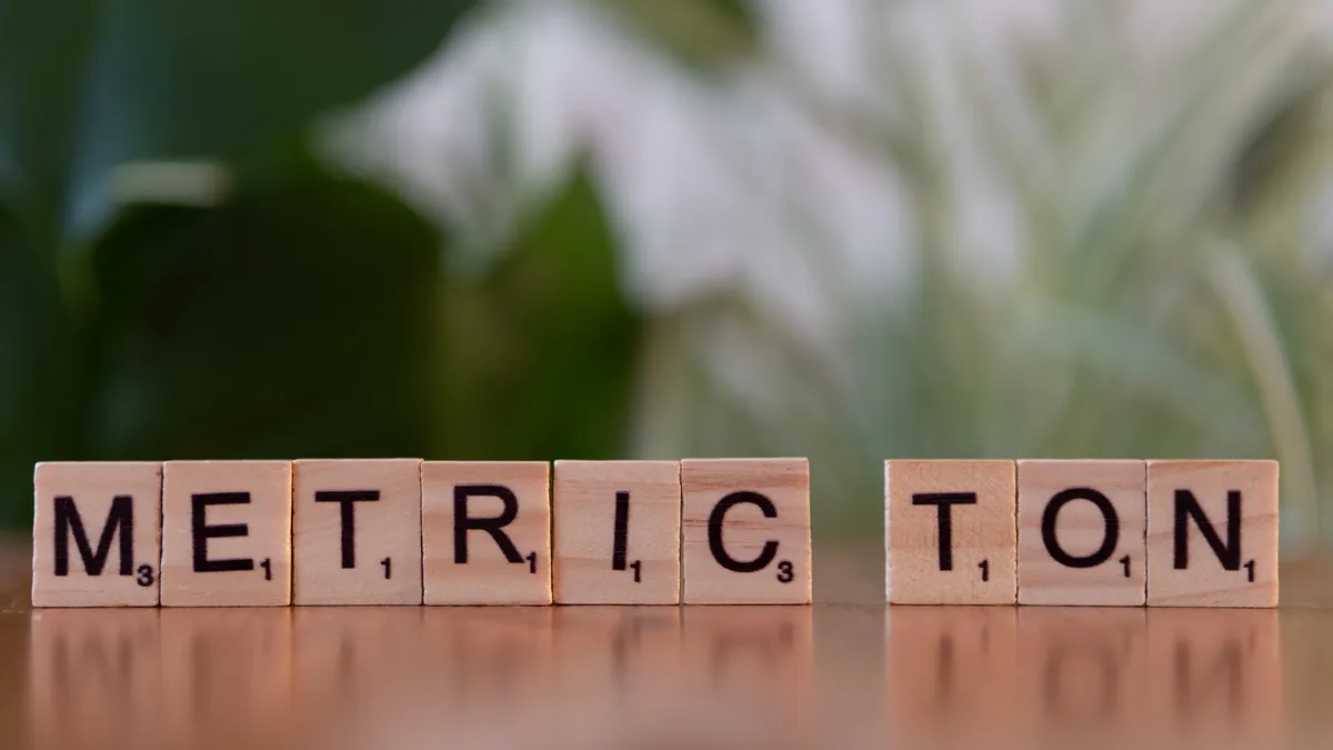 Cluster F metrics playbook: Which KPIs matter at each SaaS growth stage Cluster F metrics playbook: Which KPIs matter at each SaaS growth stage — Scrabble Tiles Spelling 'Metric Ton' on Wooden