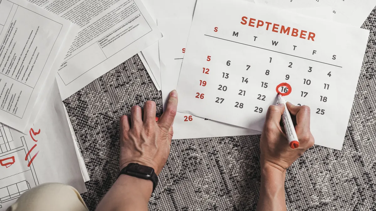 hands marking a calendar date