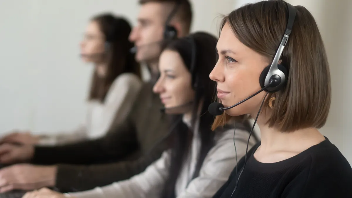 call center agents wearing headsets at computers