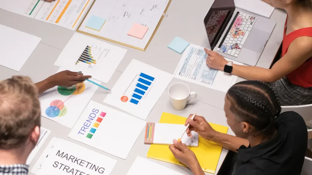 team reviewing marketing strategy documents around a table