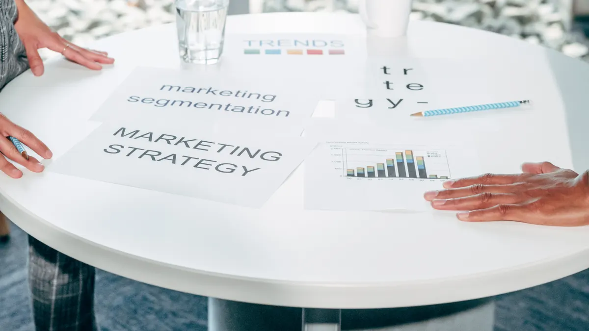 How to build an AI content workflow for SaaS marketing teams hands over marketing strategy papers on a table