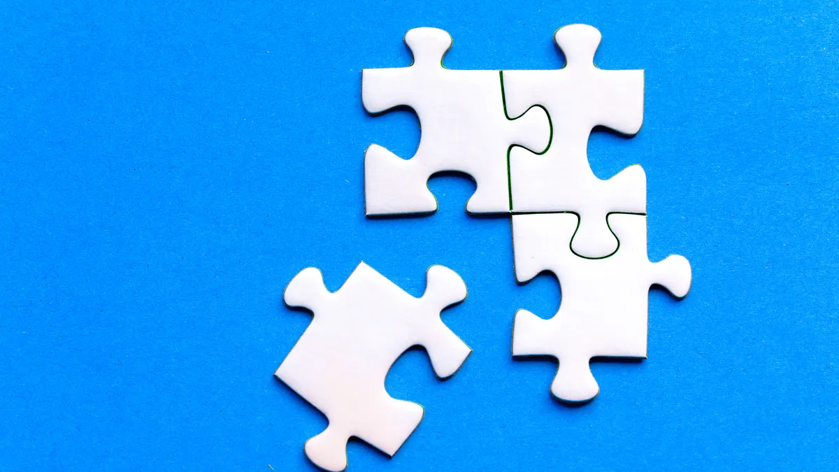 How to connect SaaS apps with Zapier for startup workflows Four white puzzle pieces on blue background