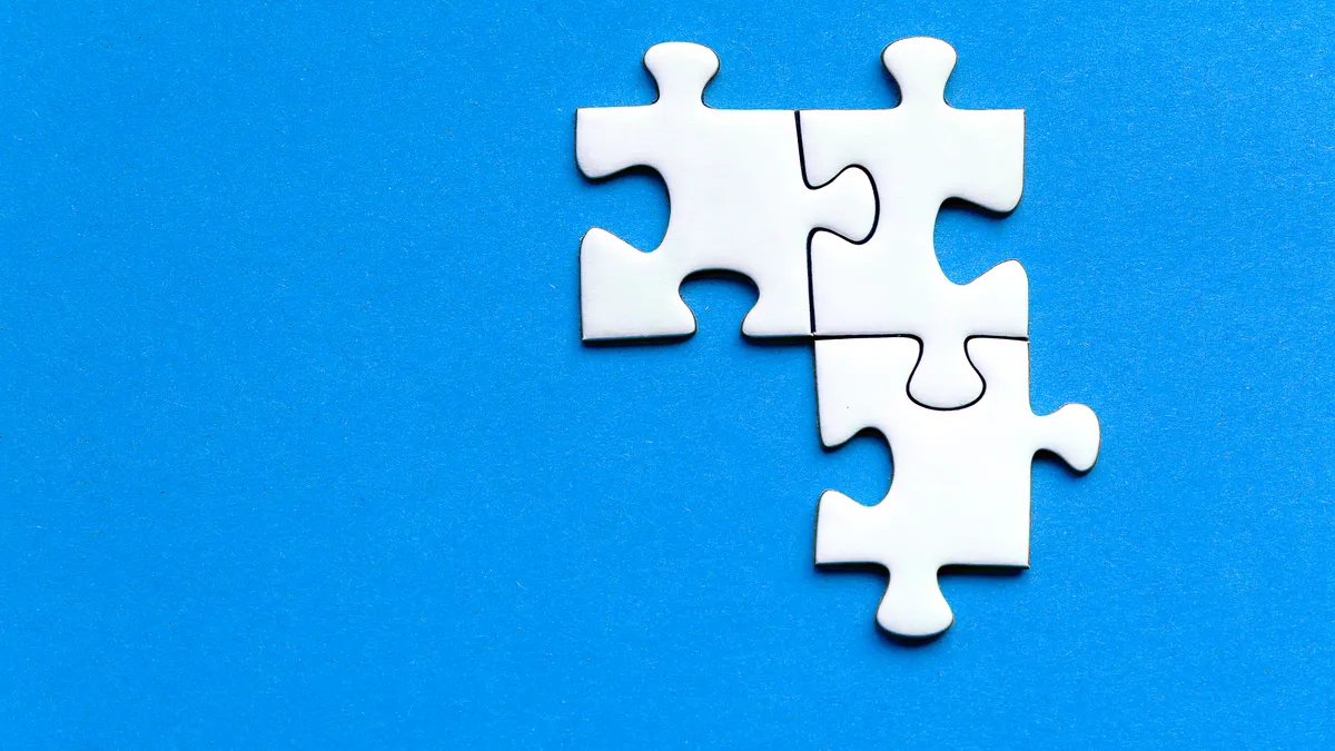 How to connect SaaS apps with Zapier for startup workflows Three white puzzle pieces on blue background